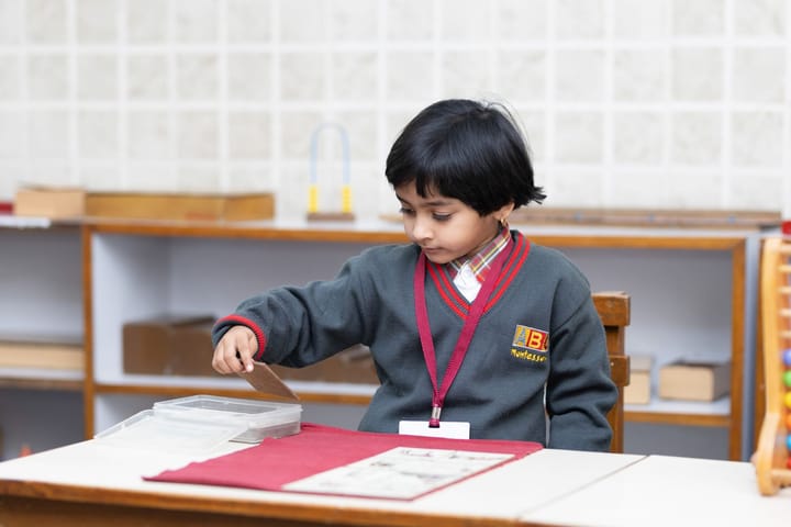 Montessori okulunda materyalle çalışan çocuk
